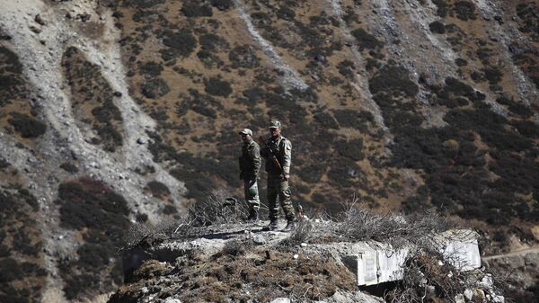 Indian army soldiers keep watch on a bunker at the Indo China border in Bumla at an altitude of 15,700 feet (4,700 meters) above sea level in Arunachal Pradesh, India, Sunday, Oct. 21, 2012. - Sputnik India