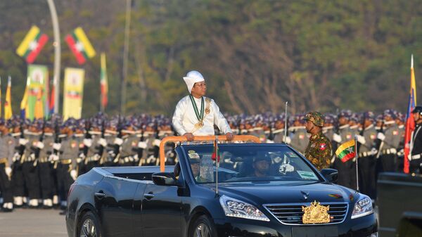 Myanmar's military chief Min Aung Hlaing stands in a car as he oversees a military display at a parade ground to mark the country's Independence Day in Naypyidaw on January 4, 2023 - Sputnik India