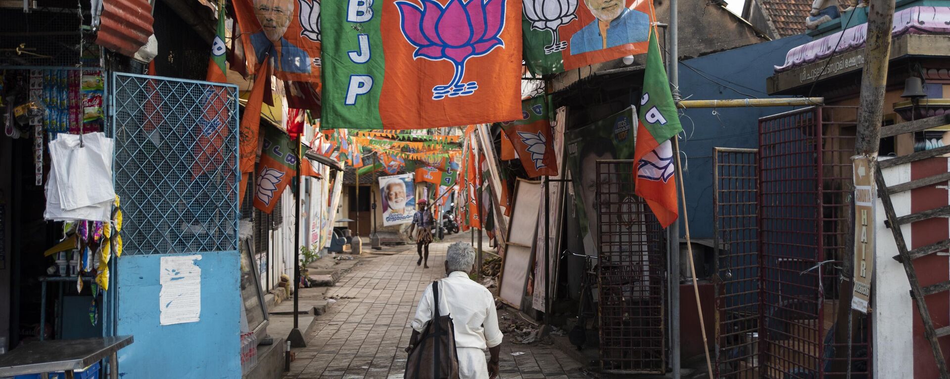 Bharatiya Janata Party (BJP) flags are displayed at a street inhabited by members of the Telugu Chetti community in Thiruvanathapuram, Kerala state, India, Saturday, April 3, 2021. - Sputnik India, 1920, 06.04.2023