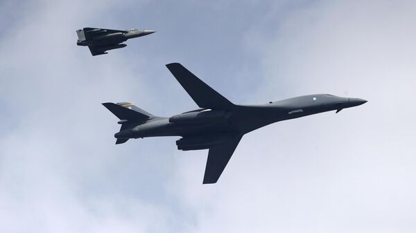 A U.S. Air Force B-1B Lancer bomber, right, flies with an Indian Air Force light combat aircraft Tejas on the inaugural day of Aero India 2021 at Yelahanka air base in Bengaluru, India, Wednesday, Feb. 3, 2021. - Sputnik India