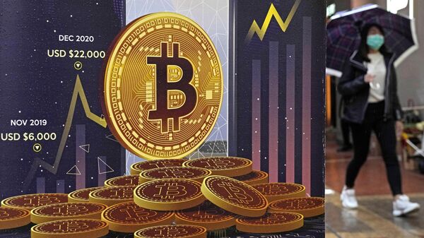 FILE - An advertisement for Bitcoin cryptocurrency is displayed on a street in Hong Kong, on Feb. 17, 2022. Bitcoin slumped to a two-year low, Wednesday, Nov. 9, and other digital assets sold off following the sudden collapse of crypto exchange FTX Trading, which has been forced to sell itself to larger rival Binance. - Sputnik India