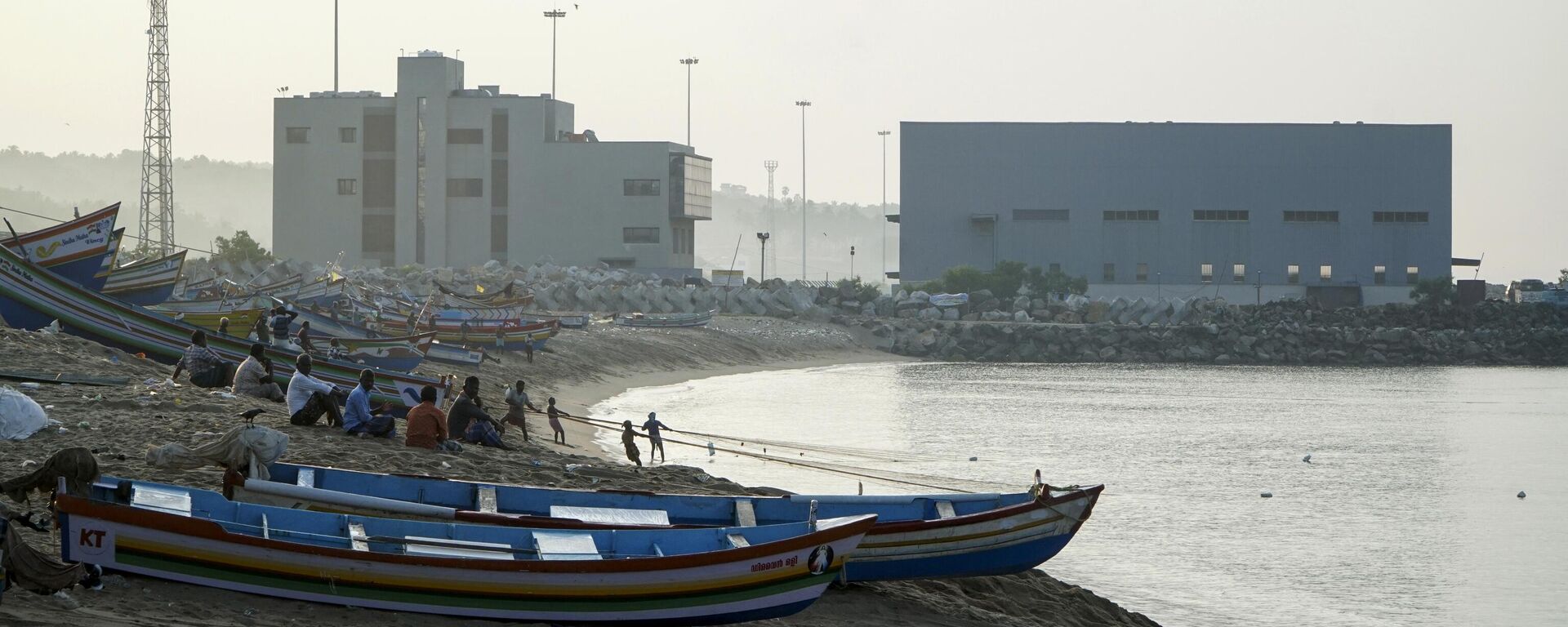 A port being constructed by Adani group is seen behind as fishermen work at Vizhinjam on the Arabian Sea coast in Kerala, India, Tuesday, Dec.6, 2022.  - Sputnik India, 1920, 16.10.2023