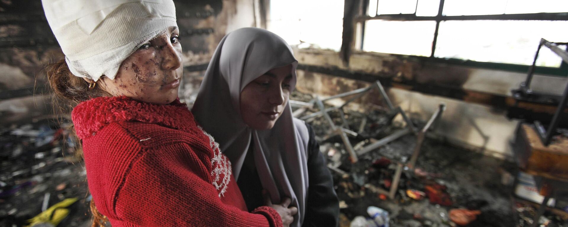 In this Monday, Jan. 19, 2009 photo, Fatma Zidane El-Banneh, 8, left, and her mother Azza, are seen after returning from the hospital to the Beit Lahiya Elementary Co-educational school, where Azza claims Fatma was burned by white phosphorus, which could not be independently verified, in Beit Lahiya, in the northern Gaza strip. - Sputnik India, 1920, 02.11.2023