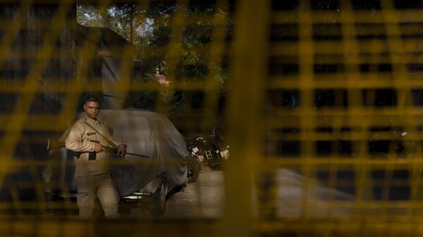 A security officer is seen behind a police barricade as he stands outside the Delhi Police's Special Cell in New Delhi, India, Tuesday, Oct. 3, 2023. - Sputnik India