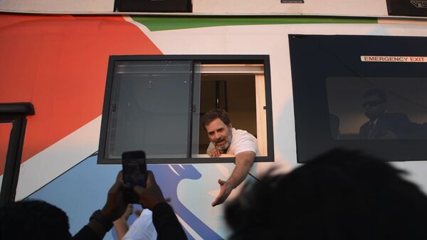 India's opposition Congress party leader Rahul Gandhi waves from a bus at the start of his two month-long cross-country march from the northeastern Indian state of Manipur in Thoubal district, Sunday, Jan. 14, 2024. - Sputnik India