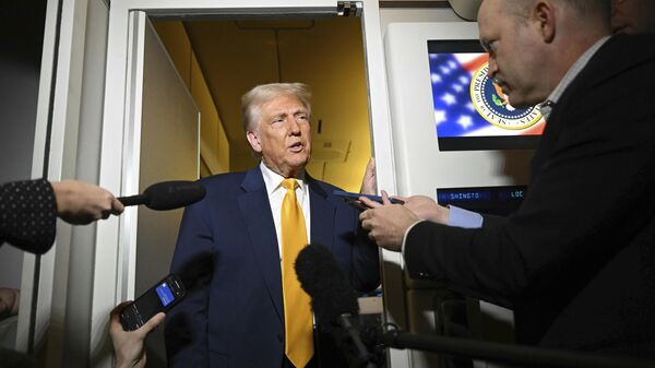 President Donald Trump speaks to the reporters on board Air Force One on the way to Miami, Saturday, April 12, 2025. - Sputnik India